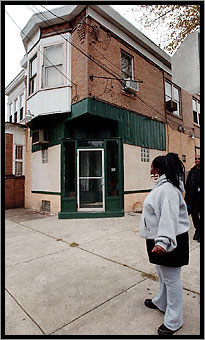 Tracey Urey stands outside the former All Nations Lounge in Camden, NJ, October 2002