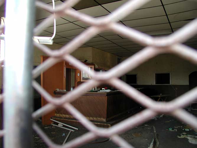 Interior of the abandoned 1473 Haddon Avenue through chain-link gate, February 22, 2004