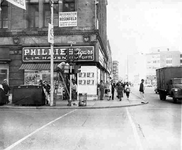 Broadway and Federal Street, 1962 — workmen repairing traffic lights; Parkade Building visible