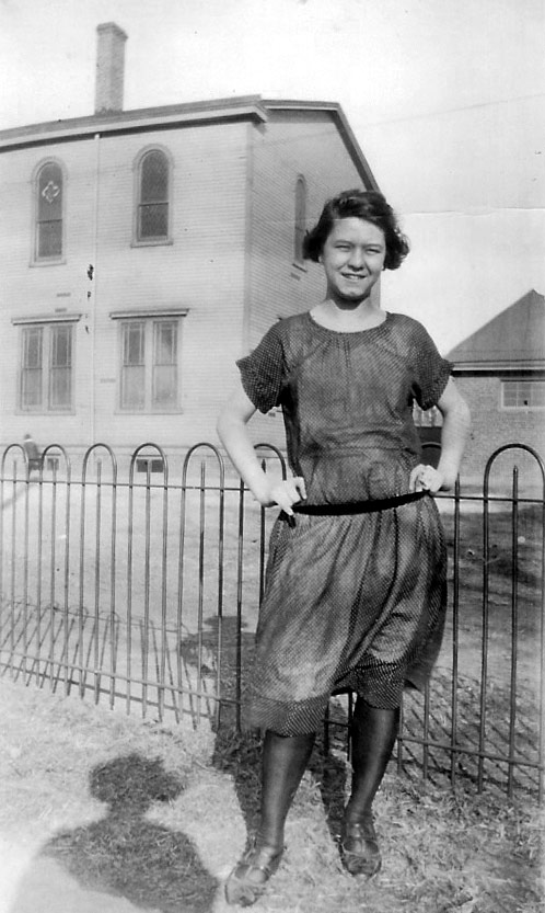 Delphine Atger, with St. Joseph's Catholic Church in background