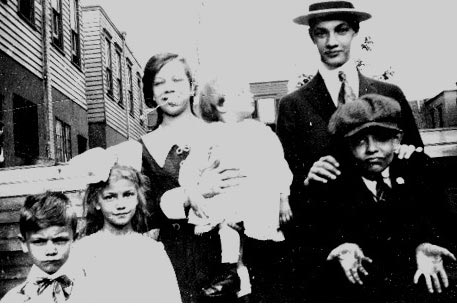 The Children of Herbert and Mary Linthicum — Grace holding Herbert Carson, Milliard (with hat), Front Row: Harry, Ethel and Alton — 1918 photo taken in rear yard at 827 Pearl Street