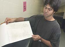 AL SCHELL/Courier-Post: Daniel Lopez, 19, a senior at Collingswood High School, goes over a sketch in preparation for painting a mural depicting diversity at the school