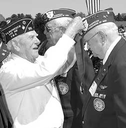 World War II Medal of Honor recipient 2nd Lt. Stephen Gregg greets former POWs John Fox and Joseph Zippilli at Burlington County's Military Service Medal Ceremony at Doughboy Field