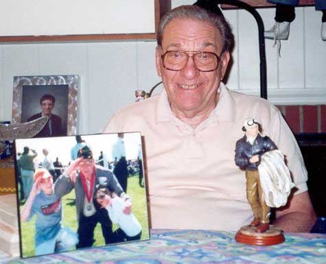 Frank Schwartz in later life, with photographs and a WWII aviator figurine