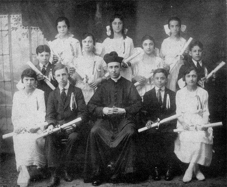 Father Brendan Shea and one of the graduation classes