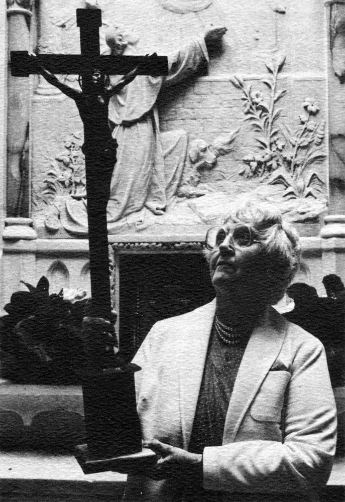Ruth Oberst, Mary Hampton's daughter, holds the Sacred Heart Mission Cross