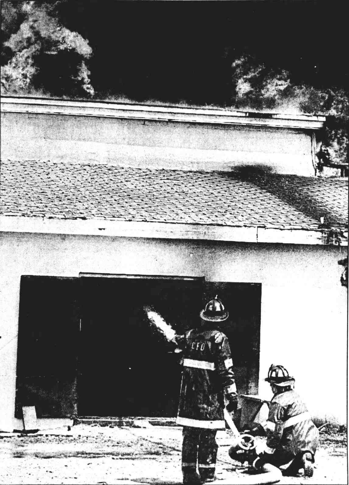 Fighting blaze: Firefighters spray water on a six-alarm fire at a bacon-cooking plant at Broadway and Jackson Street