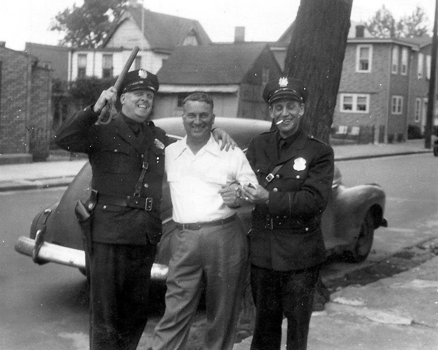 Emil Friedrichs, civilian in center with two Camden police officers, 1031 North 25th Street, 1940s