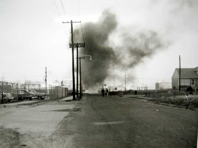 Remington Avenue intersection with North 36th Street, showing the entrance to the Campbell Soup warehouse and a house fire at the crossing guard shack, 1950s