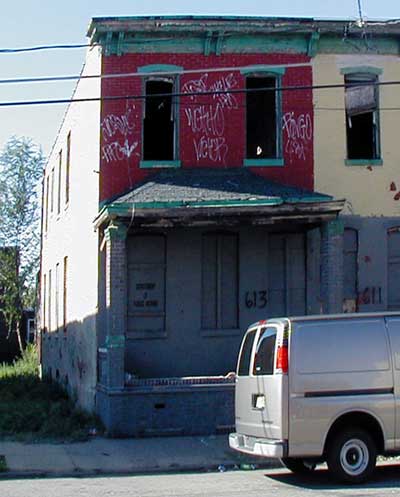 613 South 4th Street, derelict and boarded, with graffiti on the upper storey