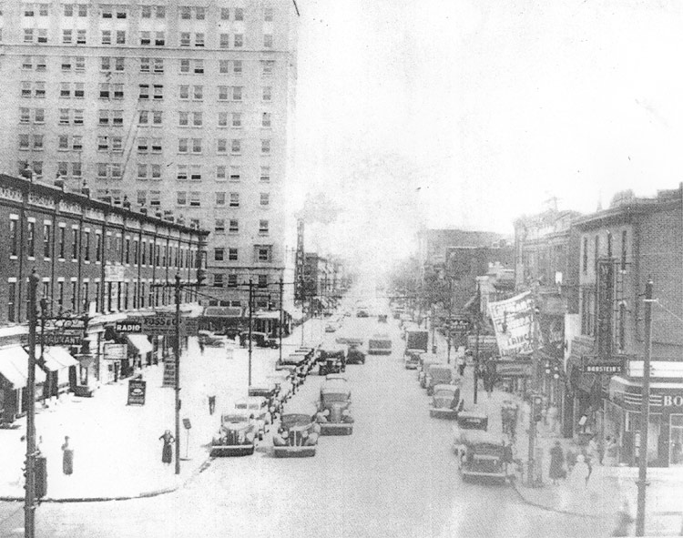 Looking south on Broadway from the elevated railroad tracks at Mickle Street, 1936, showing the Holl Block