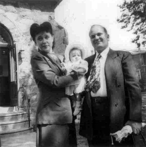Evelyn and David Reich of 2627 Cramer Street with their daughter Janice, outside Holy Trinity Lutheran Church, around 1952