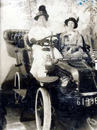 Mabel Clark at wheel with her friend Mrs. Jennie Chew, 510 Edmunds Street, c. 1910