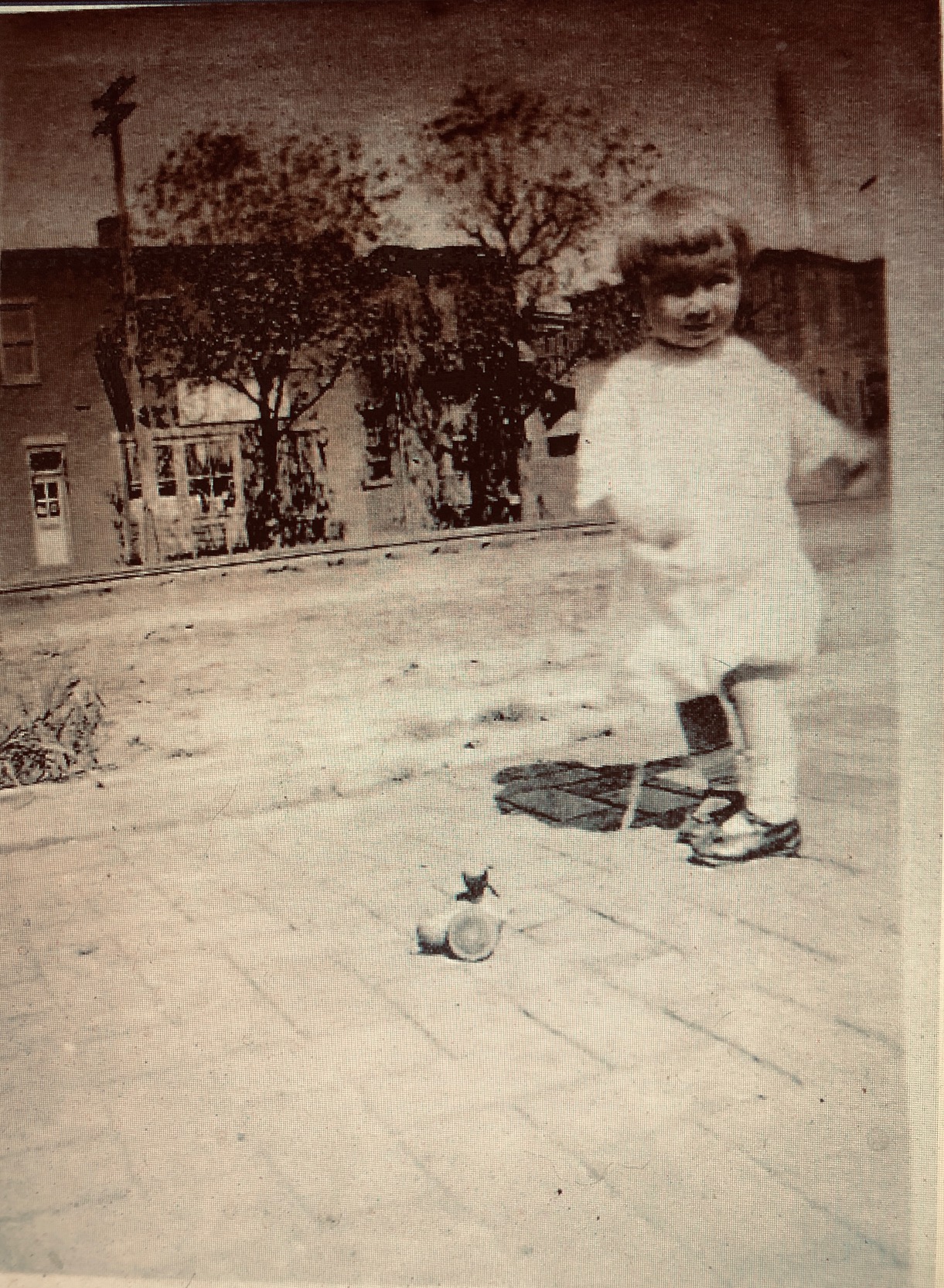 Robert Bradel, circa 1919, in front of 316 Elm Street looking across railroad tracks on Main Street