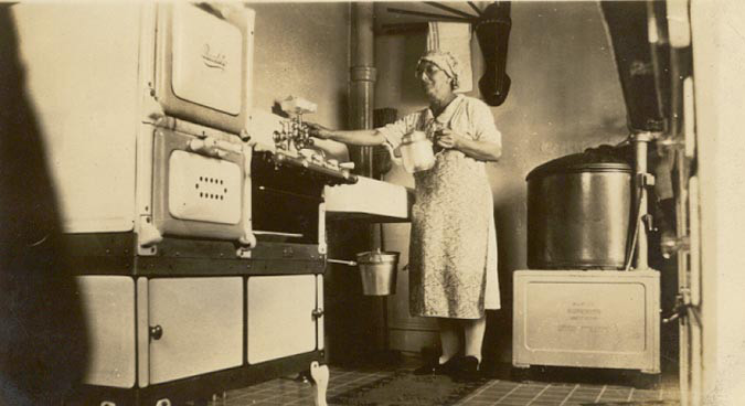 Lulu Kellman in her kitchen, 1930s-1940s