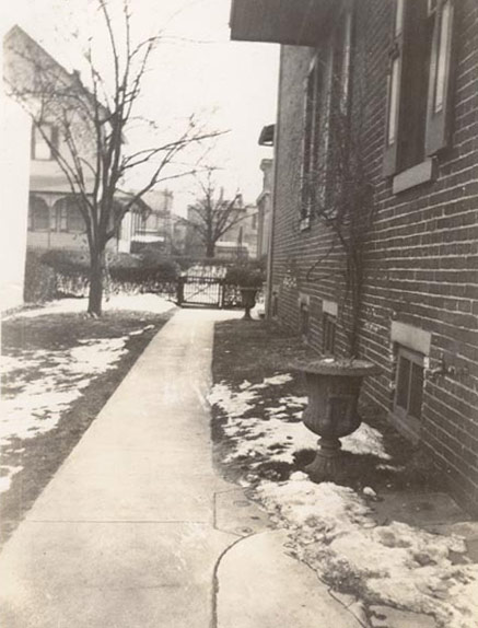 Kellman family in side yard looking towards High Street