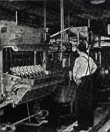 Interior of the New Jersey Bottling Company's Schlitz bottling plant at Liberty Street, Camden NJ, 1936 — worker on the bottling line