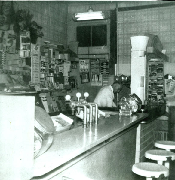 931 Market Street, Emidio Martelli working in his sweet shop with counter and soda jerks, 1940s-1950s