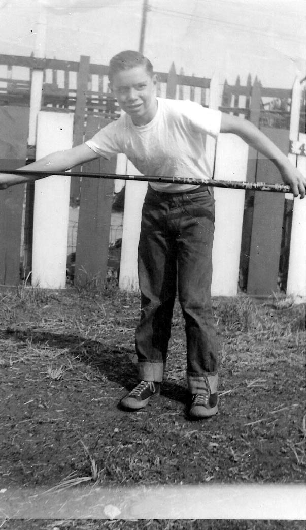 Ronald Roy Rowan with pool cue in the back yard