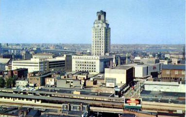 Downtown Camden around 1961 — the elevated railroad and Chinese Wall can be seen at bottom of postcard