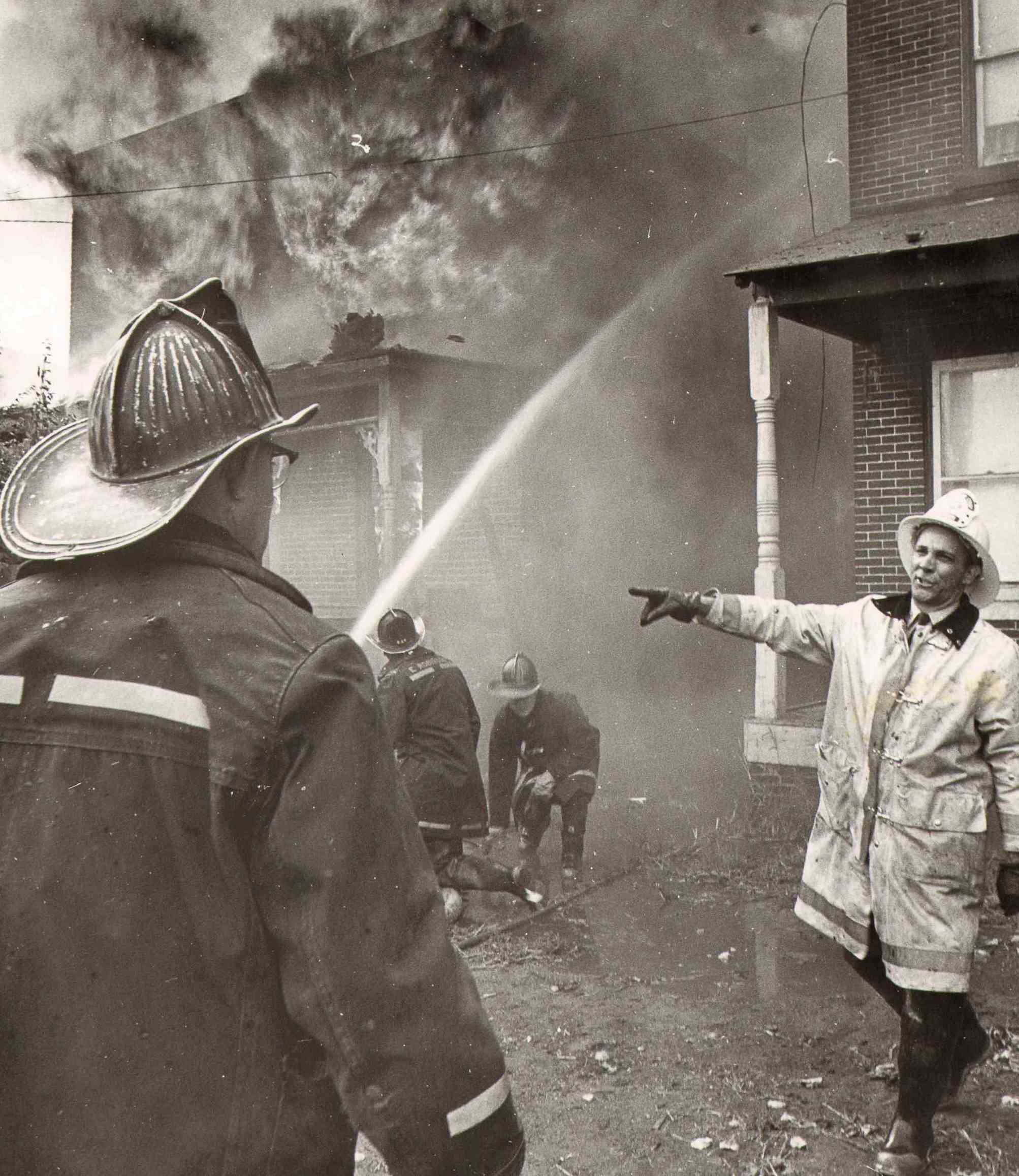 Theodore Primas directing firefighters at Railroad Avenue, spring 1974