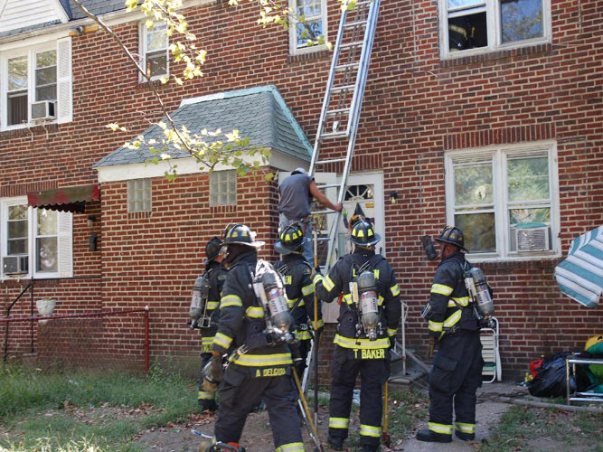 547 Pfeiffer Street fire, September 18, 2007 — photo 6: man makes it safely to ground from burning roof