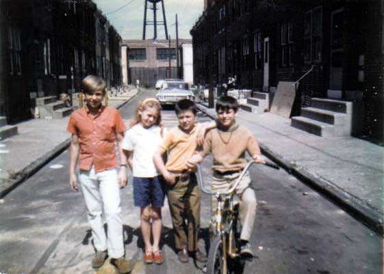 Looking north on Segal Street, summer of 1971. Floyd Miller Jr., Vennie Miller, Bobby Reed & Frank Houser Jr. John R. Evans factory at rear.
