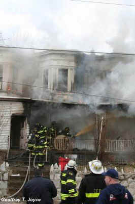 Fire fighters on porch of 935 Vine Street