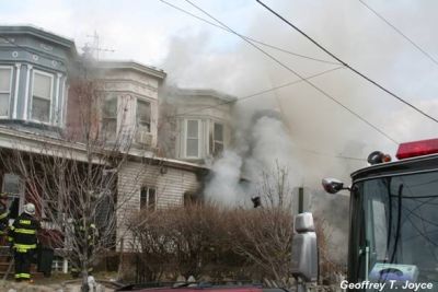 Smoke pours through door of 935 Vine Street