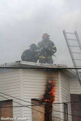 Fire fighters on roof of 939 Vine Street