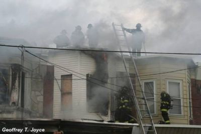 Fire fighters on the roof of 933 Vine Street