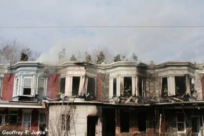Fire fighters on the roof of 931, 933, 935, and 937 Vine Street