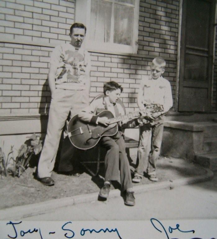 Joe Seddon Sr., Joe Seddon Jr. with guitar, and Sonny Frett on Polk Avenue, about 1951