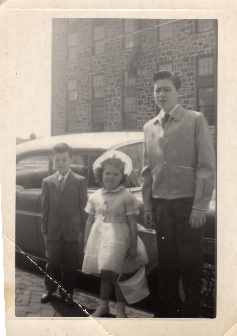 Raymond H., Michael & Linda Becoskie. In the background, the George C. Ellis box factory.