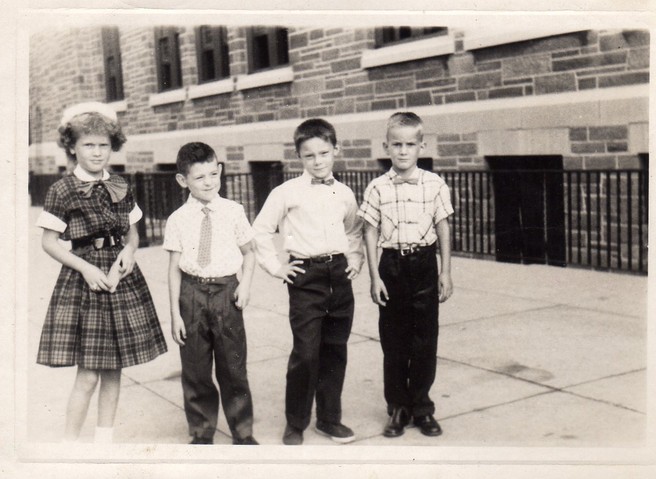 Sharon _____, Michael Becoskie, Michael Larson & Tommy McCullan. 1st Grade at side of Holy Name School, Vine Street.