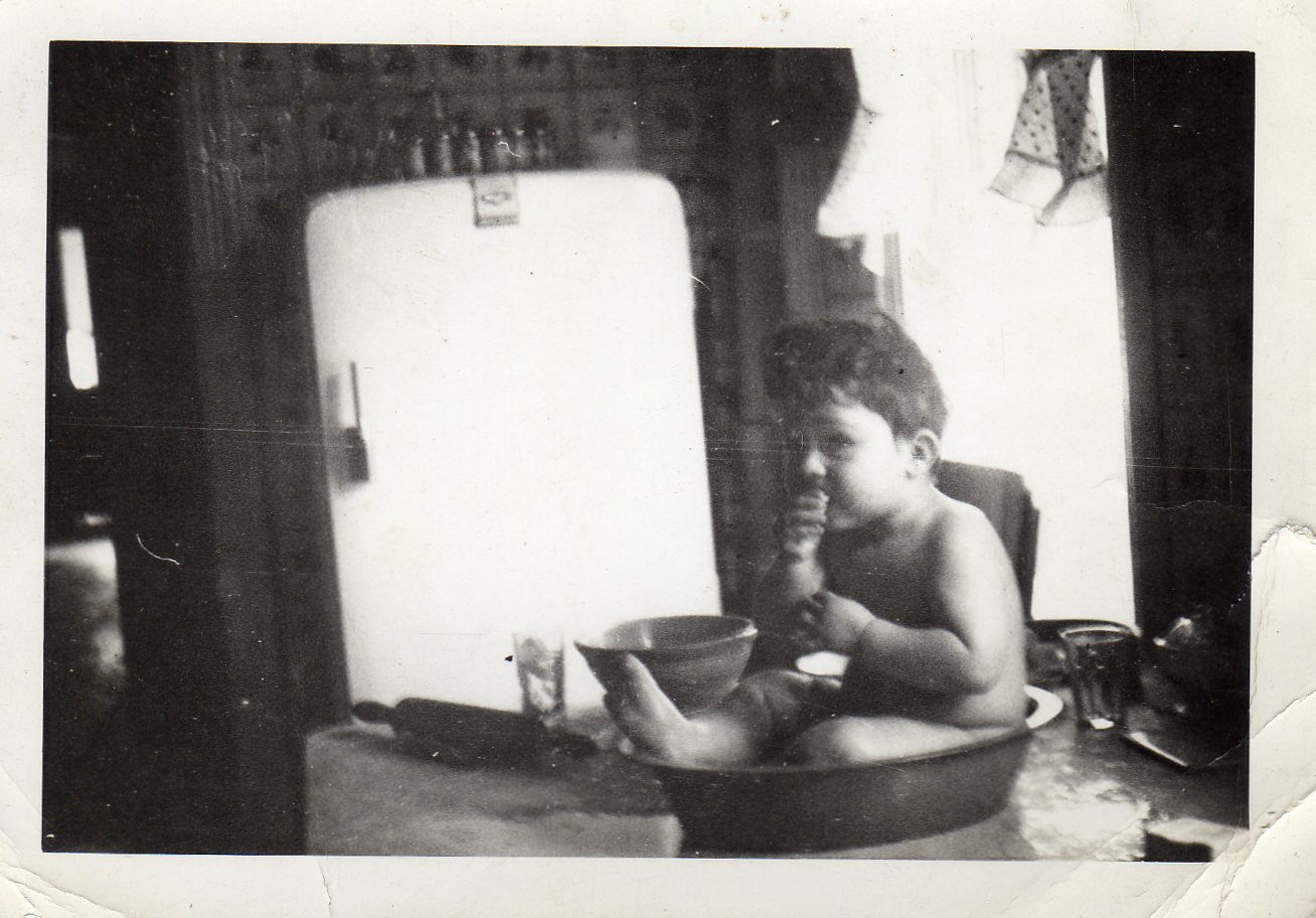 625 Elm Street, 1947 — eating sliced apples in Grandmother Catherine Kennedy's kitchen