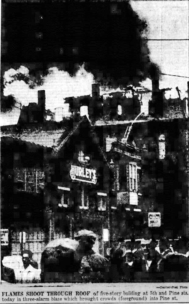 Flames shoot through roof at 5th and Pine Streets, three-alarm blaze, October 27, 1956
