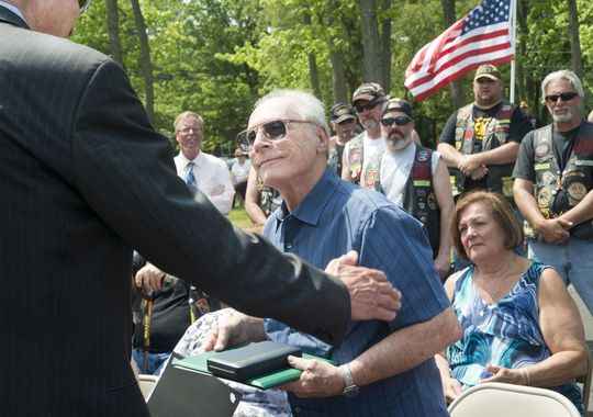 Anthony Caravello accepts the Silver Star from retired Lt. Gen. Michael Davison Jr.