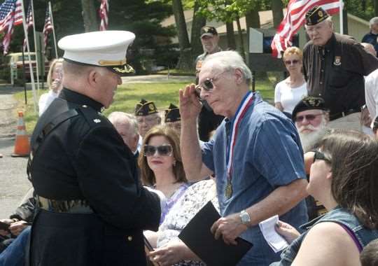 Anthony Caravello salutes Col. Al Bancroft after receiving special award
