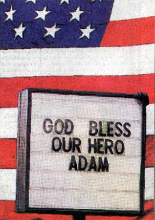 A sign salutes Adam Froehlich at Gate of Heaven Cemetery, Camden Courier-Post, April 4, 2004