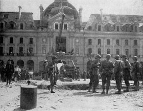 French civilians and men of the 8th Division look at the damage caused during the liberation of Rennes, France from German yoke