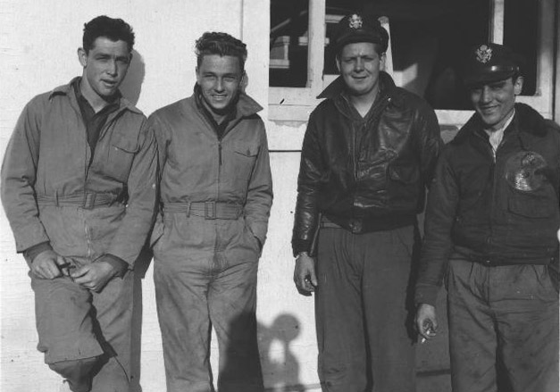 Group photo: Gordon H. McDaniel, Harry A. Parker, William E. Aron, and an unknown airman