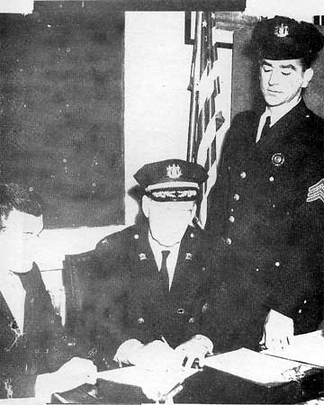Filing Application — Don Watson sitting, Sergeant Ed Yeager standing