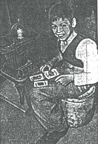 Johnny Bernard in front of a coal stove at 532 Byron Street, Camden, 1940