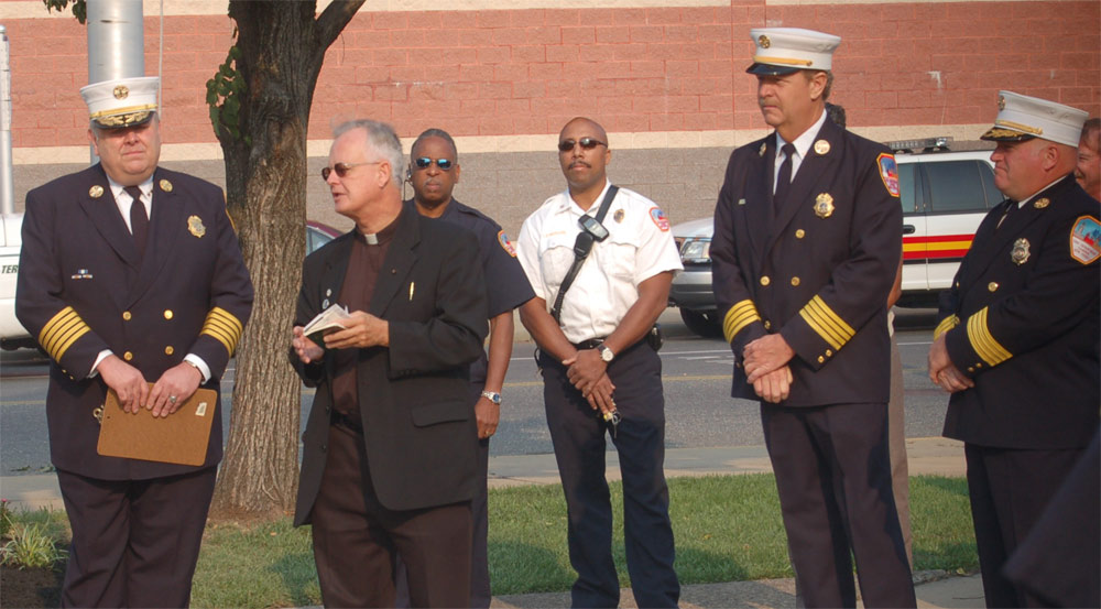 Monsignor Michael Mannion delivering the Invocation — Chief Joseph Marini, Fire Fighter Rodney Carter, Battalion Chief Darryl Lewison, Deputy Chief Greg Murphy, Deputy Chief Paul Price, Camden Firemen's Memorial Dedication, 2006