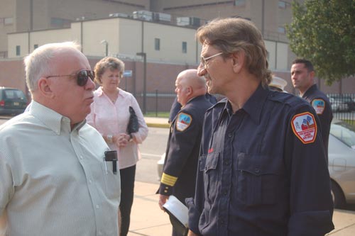 Retired Camden Fire Department member John E. 'Jack' Maher talking to Fire Fighter Larry Smith, son of fallen Fire Fighter Earl A. Smith. Behind them, Mrs. Pat Bartosz speaking with Deputy Chief Paul Price.