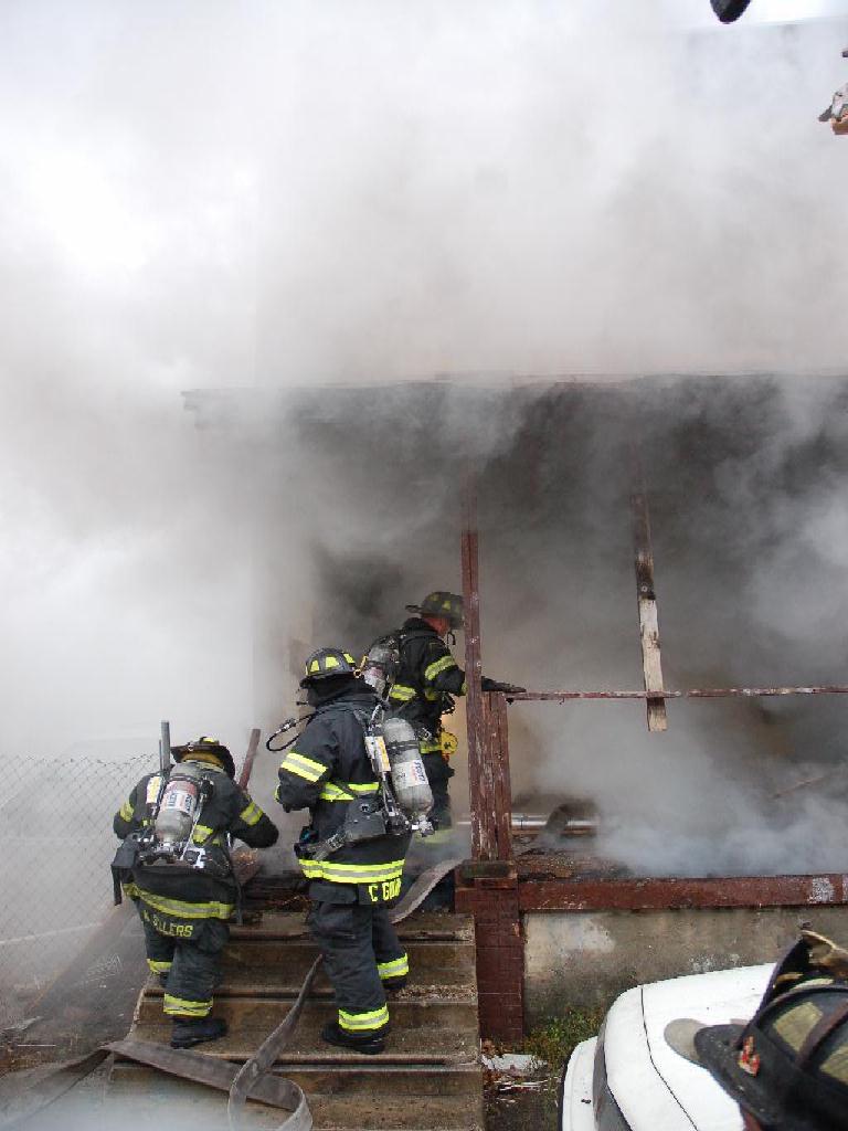 Members of Engine Company 6 going into 617 Bailey Street, December 13, 2007