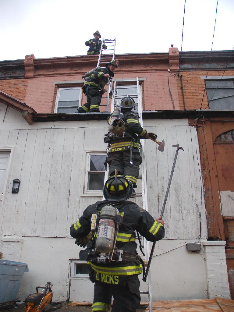 Members of Ladder Company 3 heading to the roof to ventilate, Bailey Street fire, December 13, 2007