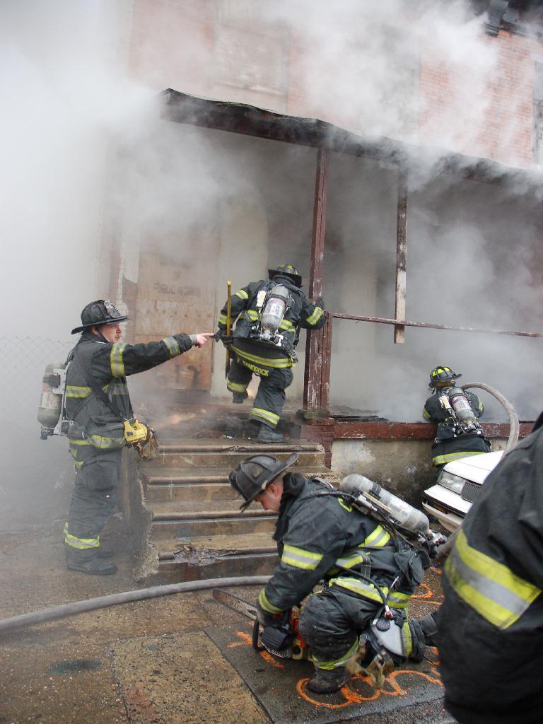 Members of Engine Company 6 going into 617 Bailey Street, December 13, 2007