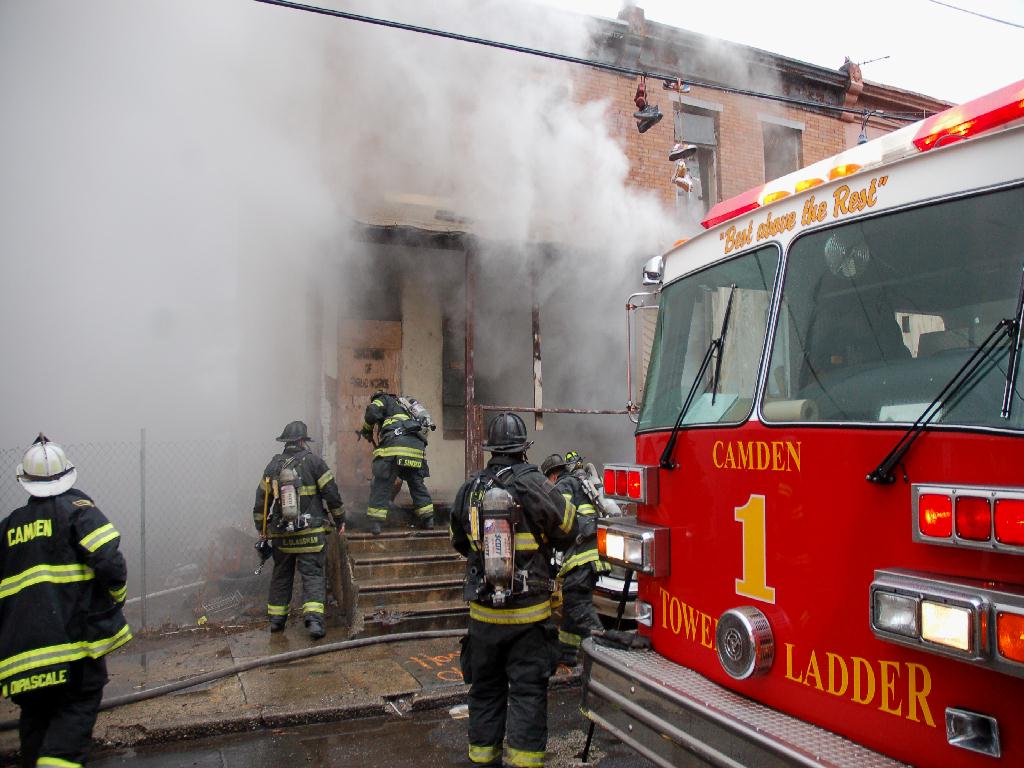 Ladder Company 1 and Rescue Company 1 making entry to the boarded-up dwellings, Bailey Street, December 13, 2007